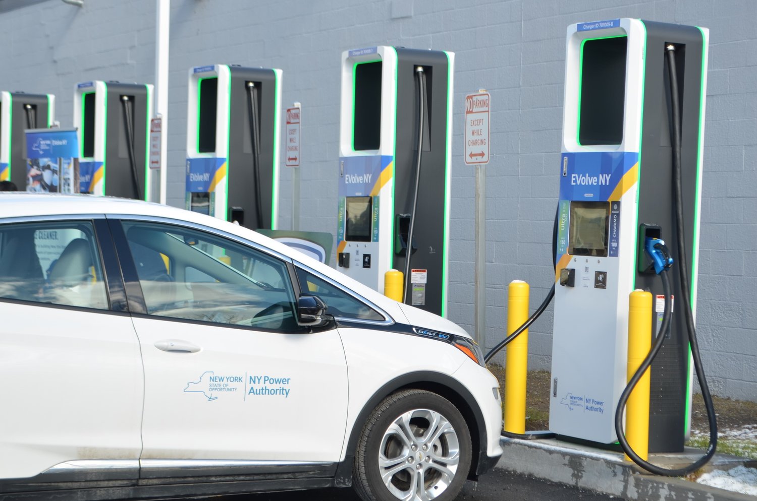 An electric vehicle with New York Power Authority (NYPA) livery sits ready at one of Hancock's new EVolve NY charging stations.